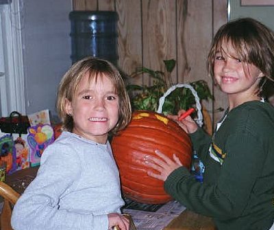 the girls carving their halloween pumpkins